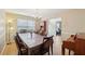 Spacious dining room with a large table set for ten, showcasing natural light and an open layout to other living areas at 3308 Hunting Creek Pass, Douglasville, GA 30135