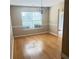 Bright and airy dining room featuring hardwood floors, natural light from the window, and elegant chandelier at 3308 Hunting Creek Pass, Douglasville, GA 30135