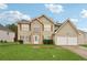 Charming two-story home with a well-maintained lawn and two-car garage, offering a blend of comfort and curb appeal at 3308 Hunting Creek Pass, Douglasville, GA 30135