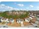 View of the community with mature trees and blue skies overlooking homes with manicured lawns in a suburban setting at 3308 Hunting Creek Pass, Douglasville, GA 30135