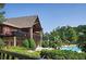 A stone and timber accented building shows off a community pool with a lush green yard at 3308 Hunting Creek Pass, Douglasville, GA 30135
