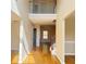 Bright foyer featuring hardwood floors, natural light, and a charming balcony overlooking the entrance area at 3308 Hunting Creek Pass, Douglasville, GA 30135