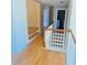 Bright hallway with beautiful hardwood floors leading to staircase and rooms at 3308 Hunting Creek Pass, Douglasville, GA 30135