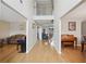 Spacious hallway with wood floors, decorative wall art, and clear sightlines to various living spaces in the home at 3308 Hunting Creek Pass, Douglasville, GA 30135