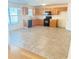 Spacious kitchen with light wood cabinets, black appliances, tile flooring, and ample counter space for cooking at 3308 Hunting Creek Pass, Douglasville, GA 30135