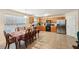 The spacious eat-in kitchen features tan tile flooring and stainless steel refrigerator at 3308 Hunting Creek Pass, Douglasville, GA 30135