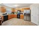 Functional kitchen featuring wood cabinets, black appliances, tile flooring, and ample counter space for cooking at 3308 Hunting Creek Pass, Douglasville, GA 30135