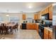 Bright kitchen featuring warm-toned cabinets, tile floors, and modern appliances with a casual dining area for everyday meals at 3308 Hunting Creek Pass, Douglasville, GA 30135