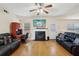 Inviting living room featuring a cozy fireplace, ceiling fan, and hardwood floors at 3308 Hunting Creek Pass, Douglasville, GA 30135