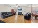 Spacious living room with laminate floors, a fireplace, and comfortable leather sofas at 3308 Hunting Creek Pass, Douglasville, GA 30135