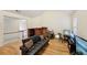 Open living room featuring wood floors, natural light, and modern furniture arrangement at 3308 Hunting Creek Pass, Douglasville, GA 30135