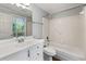 Bright bathroom featuring white vanity and a shower-tub combo at 5445 Mountain Trl, Douglasville, GA 30135