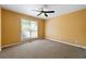 Bedroom with neutral carpet, ceiling fan, and large window at 5445 Mountain Trl, Douglasville, GA 30135