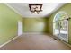 Bedroom with neutral carpet and large window providing natural light at 5445 Mountain Trl, Douglasville, GA 30135