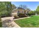 Beautiful home with a long driveway, green lawn, and mature landscaping at 5445 Mountain Trl, Douglasville, GA 30135