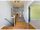 View of the foyer with hardwood floors and stairs, leading to the living room with a fireplace at 5445 Mountain Trl, Douglasville, GA 30135