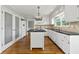 Classic kitchen featuring white cabinets, black countertops, and a center island at 5445 Mountain Trl, Douglasville, GA 30135