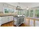 Bright kitchen with a central island, hardwood floors, and large windows overlooking the yard at 5445 Mountain Trl, Douglasville, GA 30135