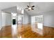 Open-concept living room with hardwood floors, high ceiling, and access to the dining room at 5445 Mountain Trl, Douglasville, GA 30135
