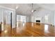 Bright living room showcasing hardwood floors, fireplace, and access to the dining room and backyard at 5445 Mountain Trl, Douglasville, GA 30135