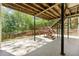 Spacious outdoor patio and staircase leading to an upper deck with lush greenery and a fenced yard at 5445 Mountain Trl, Douglasville, GA 30135