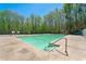 A refreshing community pool is surrounded by lush greenery, offering a serene retreat for relaxation and recreation at 5445 Mountain Trl, Douglasville, GA 30135