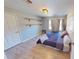 Bright bedroom featuring two floating shelves above a simple platform bed with light hardwood flooring at 1317 Bustling Sw Ln, Marietta, GA 30064