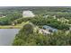 Aerial view of property, lake, tennis courts, lush trees, and surrounding neighborhood at 140 Discovery Lake Dr, Fayetteville, GA 30215