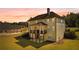 Expansive backyard featuring an upper deck, lower patio, and a well-maintained lawn perfect for outdoor activities at 140 Discovery Lake Dr, Fayetteville, GA 30215