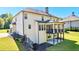 Home's backyard showcasing a covered deck, well-maintained lawn, and additional outdoor space at 140 Discovery Lake Dr, Fayetteville, GA 30215