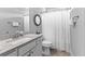A bathroom features a shower and tub, vanity with granite countertop, framed mirror and neutral walls at 140 Discovery Lake Dr, Fayetteville, GA 30215
