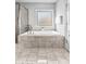 Tiled bathtub with frosted glass window, shower, and tile flooring at 140 Discovery Lake Dr, Fayetteville, GA 30215