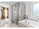Bathtub with shower and view to another room in the home, featuring a flower accent at 140 Discovery Lake Dr, Fayetteville, GA 30215