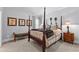 Bedroom featuring four-poster bed, neutral decor, side tables and natural light at 140 Discovery Lake Dr, Fayetteville, GA 30215