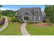 Exterior of the community clubhouse, with manicured lawn and paved walkway at 140 Discovery Lake Dr, Fayetteville, GA 30215