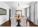 A formal dining room features a large wooden table, upholstered chairs, and elegant chandelier at 140 Discovery Lake Dr, Fayetteville, GA 30215