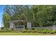 Stone entryway sign for 'The Canoe Club' surrounded by manicured landscaping and mature trees at 140 Discovery Lake Dr, Fayetteville, GA 30215
