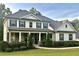 Beautiful two-story home with a large front porch and well-manicured landscaping creating great curb appeal at 140 Discovery Lake Dr, Fayetteville, GA 30215