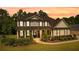 Charming two-story home with manicured landscaping and welcoming covered front porch at 140 Discovery Lake Dr, Fayetteville, GA 30215