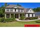 Charming two-story home featuring a manicured lawn, covered porch, and classic architectural details at 140 Discovery Lake Dr, Fayetteville, GA 30215