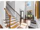 Bright foyer with hardwood floors, staircase, and elegant chandelier at 140 Discovery Lake Dr, Fayetteville, GA 30215