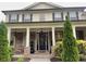 Charming home exterior with stone accents, covered porch, decorative columns, and lush front yard landscaping at 140 Discovery Lake Dr, Fayetteville, GA 30215