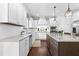 Bright, island kitchen featuring white cabinets, granite counters, and stainless steel appliances at 140 Discovery Lake Dr, Fayetteville, GA 30215
