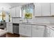 Bright eat-in kitchen features white cabinets, granite counters, stainless appliances, and large window with natural light at 140 Discovery Lake Dr, Fayetteville, GA 30215