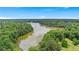 Scenic aerial view of the lake surrounded by lush trees on a beautiful day at 140 Discovery Lake Dr, Fayetteville, GA 30215