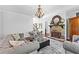 Cozy living room featuring a stone fireplace and elegant chandelier at 140 Discovery Lake Dr, Fayetteville, GA 30215
