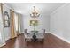 A living room features hardwood floors, neutral paint, a decorative chandelier, and elegant decor at 140 Discovery Lake Dr, Fayetteville, GA 30215