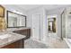 Main bathroom features a double sink vanity, tiled flooring, glass shower, and leads to the main bedroom at 140 Discovery Lake Dr, Fayetteville, GA 30215