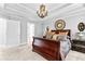 Main bedroom featuring a decorative bed with decorative mirror and door that leads to the main bathroom at 140 Discovery Lake Dr, Fayetteville, GA 30215
