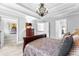 Main bedroom featuring tray ceilings, decorative accents, and doors leading to additional rooms at 140 Discovery Lake Dr, Fayetteville, GA 30215